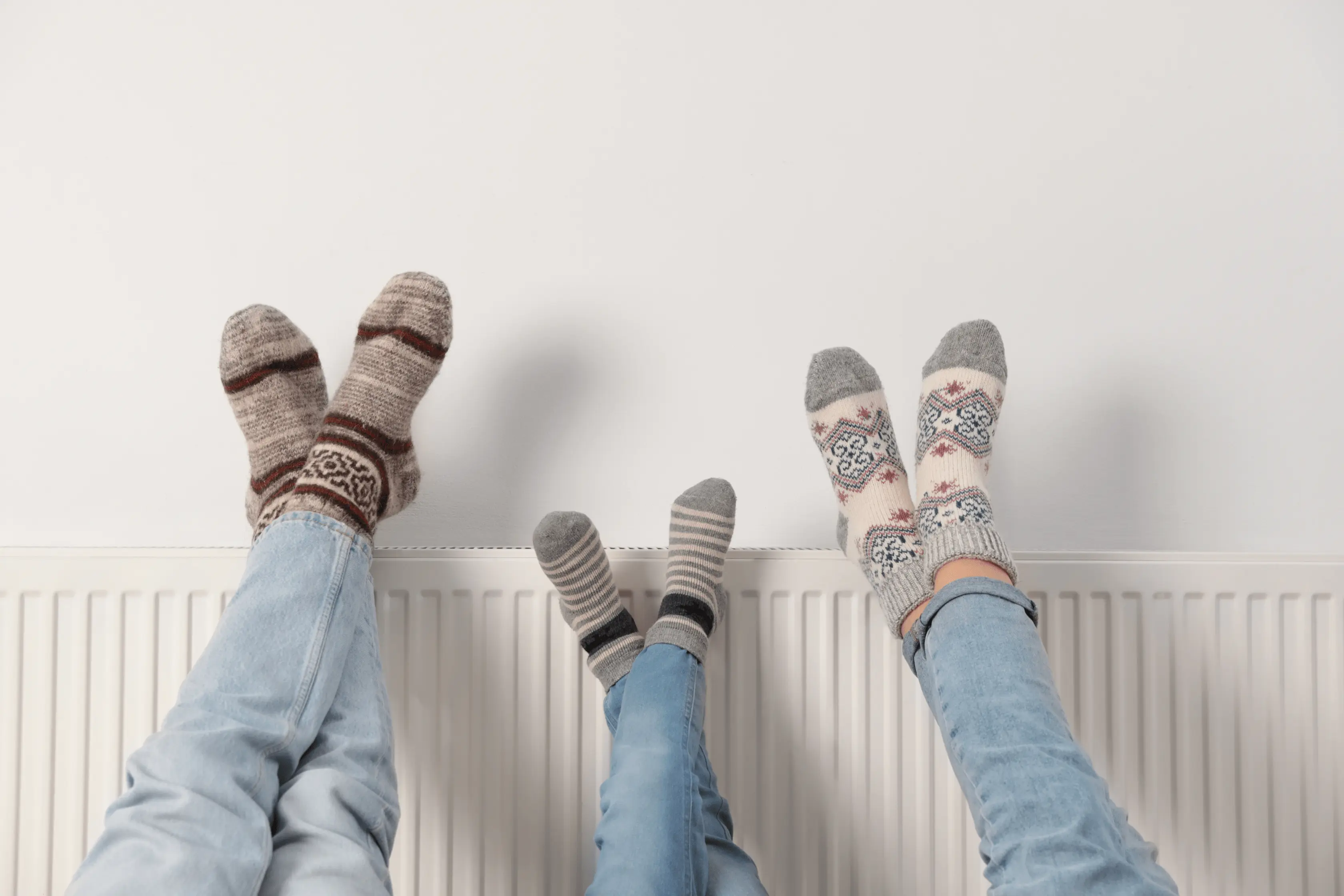Home Radiator With Homeowners Feet Resting On Top
